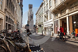 Street scene with bikes in central Bruges, with 13th century Belfry tower. photo