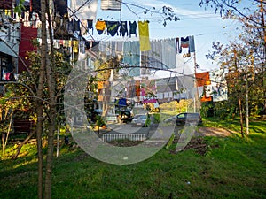 Clothes are dried on a line. Colorful houses. Urban environment. Beautiful sunny day in the city. Yard in Batumi. Aesthetics of