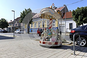 A street scene with a little carousel in Neusiedl am See, Burgenland, Austria