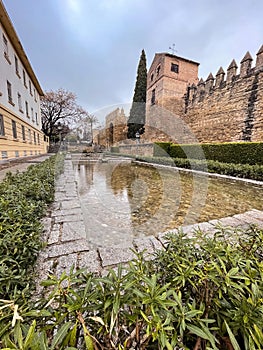 Cairuan Street with pools and the walls of the Almodovar Gate in Cordoba, Spain