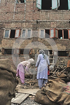 Daily street scenes from old Srinagar with hardworking people building buildings affected by violent strikes that happen of. India