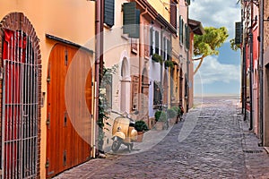 Street with scooter and old houses in Rimini