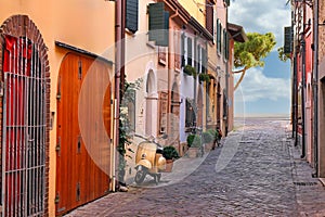 Street with scooter and old houses in Rimini photo