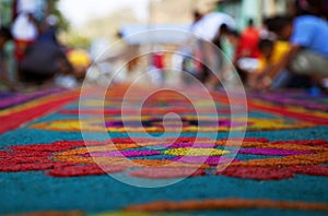 Street screen of locals producing alfombra, sawdust carpets with colorful designs for Semana Santa, Easter on the streets of Lake photo