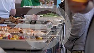 Street Seller Weighs Kebabs in a Lunch Box on an Electronic Scale. Zoom