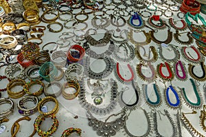 Street shop selling metal women ornaments or jewelries like necklace, chains, bangles, rings, bracelets. Chennai India Feb 25 2017