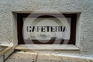 Street side rustic vintage cafeteria print signage on white background in dark wooden frame on white texture concrete wall