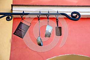 Street sign with antique cooking utensils in Prague