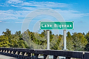 street sign of Atchafalaya Basin Bridge, Interstate 10, crossing over Lake Bigeaux. Green road sign on the concrete bridge