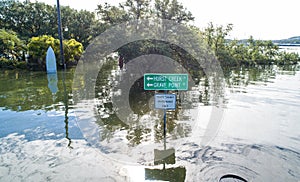 Street sign completely under water after massive flooding photo
