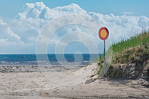 Street sign on a empty road with sea and sky in background. no entry. wrong way