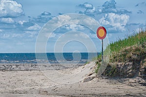 Street sign on a empty road with sea and sky in background. no entry. wrong way