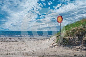 Street sign on a empty road with sea and sky in background. no entry. wrong way