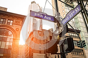 Street sign of Fifth Ave and West 33rd St at sunset in New York
