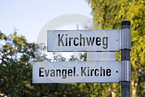 Street sign with the German text `Kirchweg` and `Evangel. Kirche`