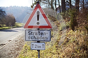 street sign in germany warning Slippery road