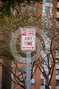 a street sign indicating no stopping parking any time to turn