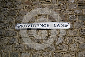 Street sign for Providence Lane on stone wall