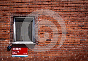 Street sign on a red brick wall in Istanbul