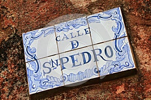 Street sign on a stone wall in Colonia del Sacramento, Uruguay