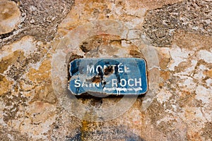 Street sign on the stone walls of Bonifacio, Corsica