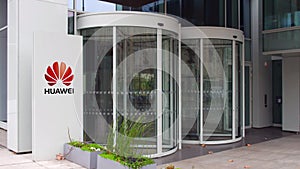 Street signage board with Huawei logo. Modern office building. Editorial 3D rendering