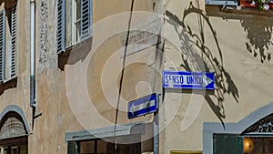 Street signs on old buildings in Bergamo, Italy