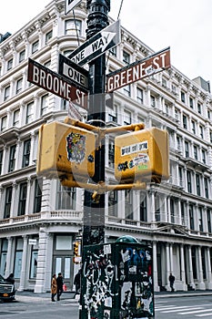 Street signs and traffic lights with stickers in SOHO New York City