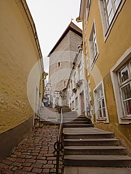 Street with stairs and cbblestone to medieval defense tower in Tallinn