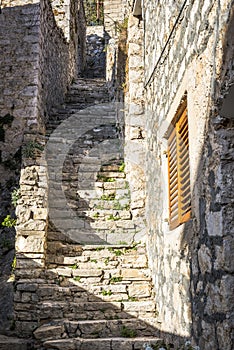 Street with stone stairs leading to the hill in Skradin town, Croatia