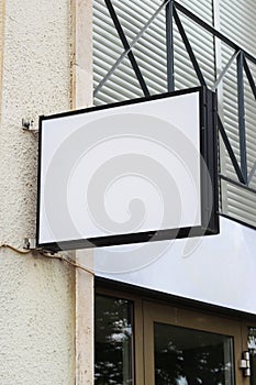 Street storefront shop, cafe, restaurant mounted signboard mock up design template. Blank white store sign design mockup