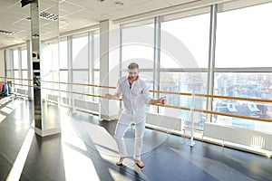 Street style dancer making hand movements near big window.