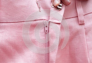 Street style fashion linen shorts close-up, classic summer style outfit, warm pink colors