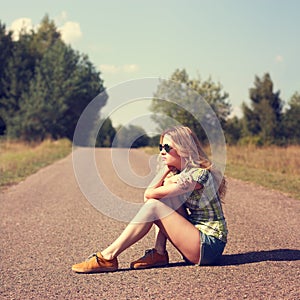 Street Style Fashion Woman Sitting on the Road Outdoors photo
