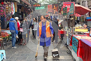 Street sweeper at work at the Beiyuanmen Muslim Market in Xian, China