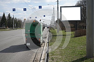 Street sweeper machine cleans street with brushes and water. Municipal car for cleaning and brush roads or sidewalks