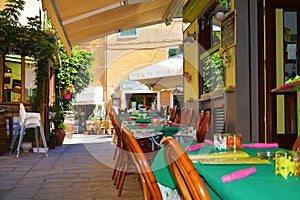 Street and tables in Porto Azzurro, in Elba island, Italy photo