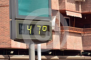 Street thermometer marking 47 degrees photo