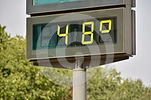 Street thermometer marking 48 degrees photo