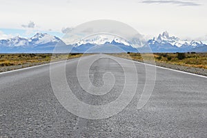 Street to Glacier National Park in El Chalten, Argentina, Patagonia with snow covered Fitz Roy Mountain in background