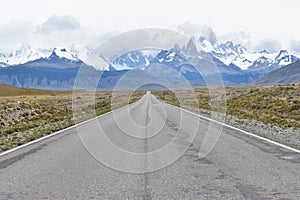 Street to Glacier National Park in El Chalten, Argentina, Patagonia with snow covered Fitz Roy Mountain in background