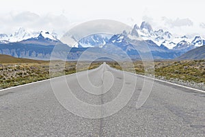 Street to Glacier National Park in El Chalten, Argentina, Patagonia with snow covered Fitz Roy Mountain in background