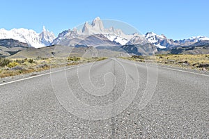 Street to Glacier National Park in El Chalten, Argentina, Patagonia with snow covered Fitz Roy Mountain in background