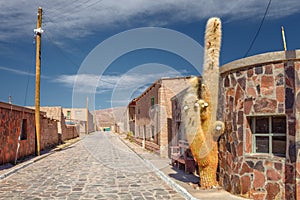 Street of the town of Cariquima, with giant cacti, near Colchane, in the Tarapaca region, in the foothills of the Cariquima mount photo