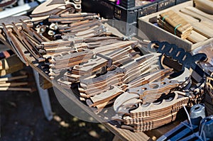 Street trade. The counter with wooden souvenirs. Knives and sabers made of plywood, wooden combs and other products. Daytime. No