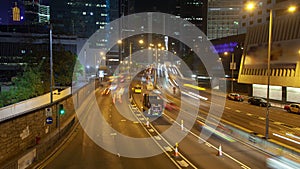 Street traffic in Hong Kong at night time-lapse. pan up