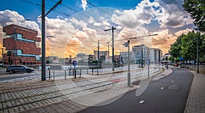 Street and tram track near modern small island in city center of Antwerp, Belgium.