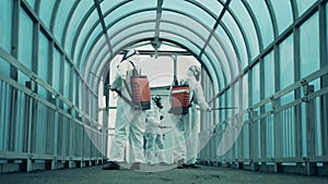 Street tunnel is being sanitized by a group of disinfection workers