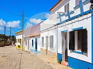 Street with typical Portuguese white houses in Sagres, southern Algarve of Portugal