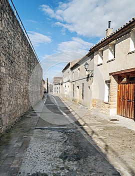 Street of UrueÃÂ±a with stone wall photo